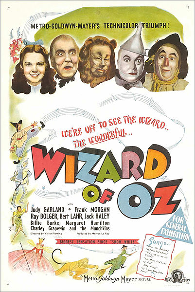 A poster from the movie The Wizard of Oz. It shows all of the main characters faces at the top; Dorothy, the Wizard, the Cowardly Lion, the Tin Man, and the Scarecrow.
