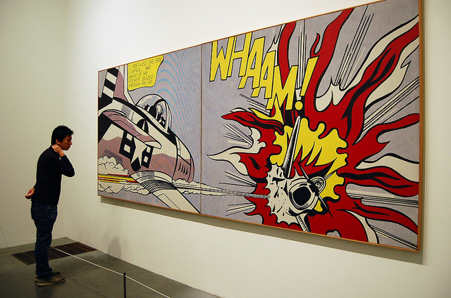 A young man observing a painting entitled ‘Whaam!’ by Roy Lichtenstein