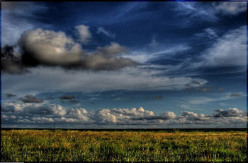 A photograph of rain clouds over a Texas prairie
