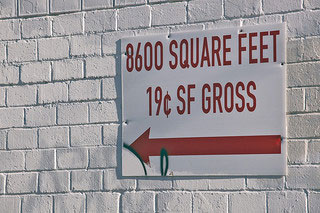 A sign on an outdoor wall that reads “8600 Square Feet 19Â¢ SF Gross”