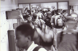 A photograph of students moving in a school hallway