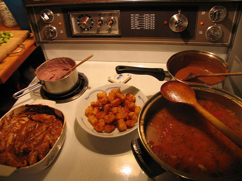 A photograph of various food being prepared on a stove