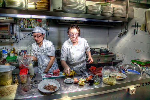 Two female cooks in a restaurant kitchen