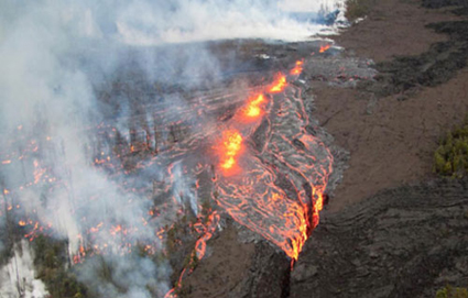 A photograph of glowing lava seeping from a fissure in the earth’s crust