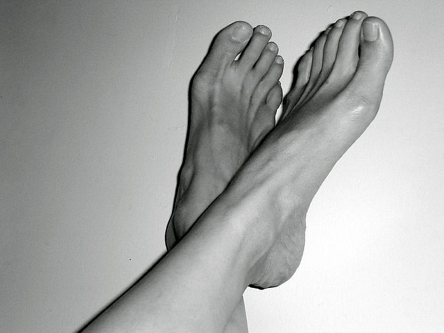 A point of view photograph of the photographer’s bare feet.