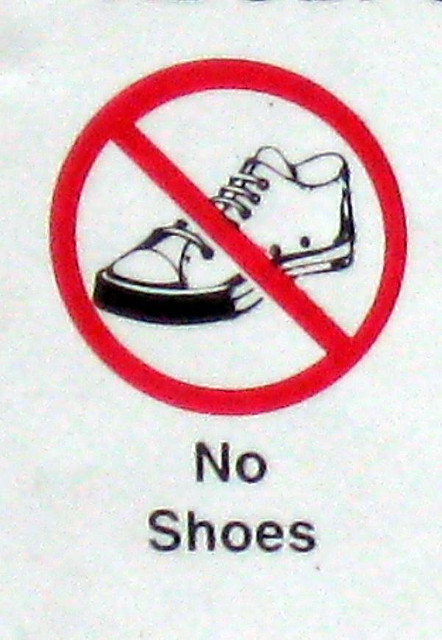 A sign that reads “No Shoes.” It has a picture of a shoe with a line through it.