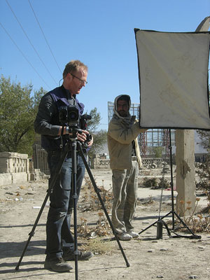 A photographer sets up his equipment in Afghanistan.