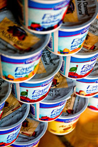 A photograph of a stack of yogurt containers