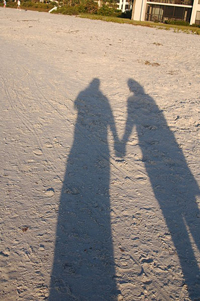 A photograph of a shadow of two people holding hands