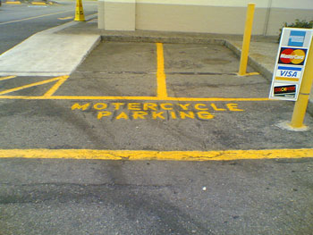 A photograph of a box that reads “motercycle parking”; motorcycle is misspelled.