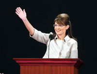 Photo of Sarah Palin waving from a podium.