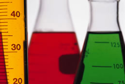 This is a picture of three glass beakers filled with colored liquids.