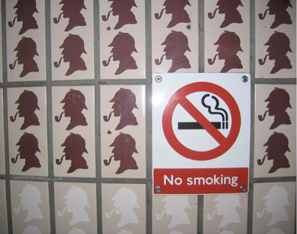 Wall from the Baker Street Station of the London Underground – a pattern of tiles with Sherlock Holmes smoking a pipe, and a “No Smoking” sign