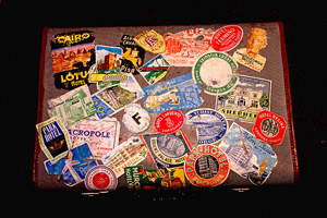 Image of a vintage style suitcase with travel stickers.