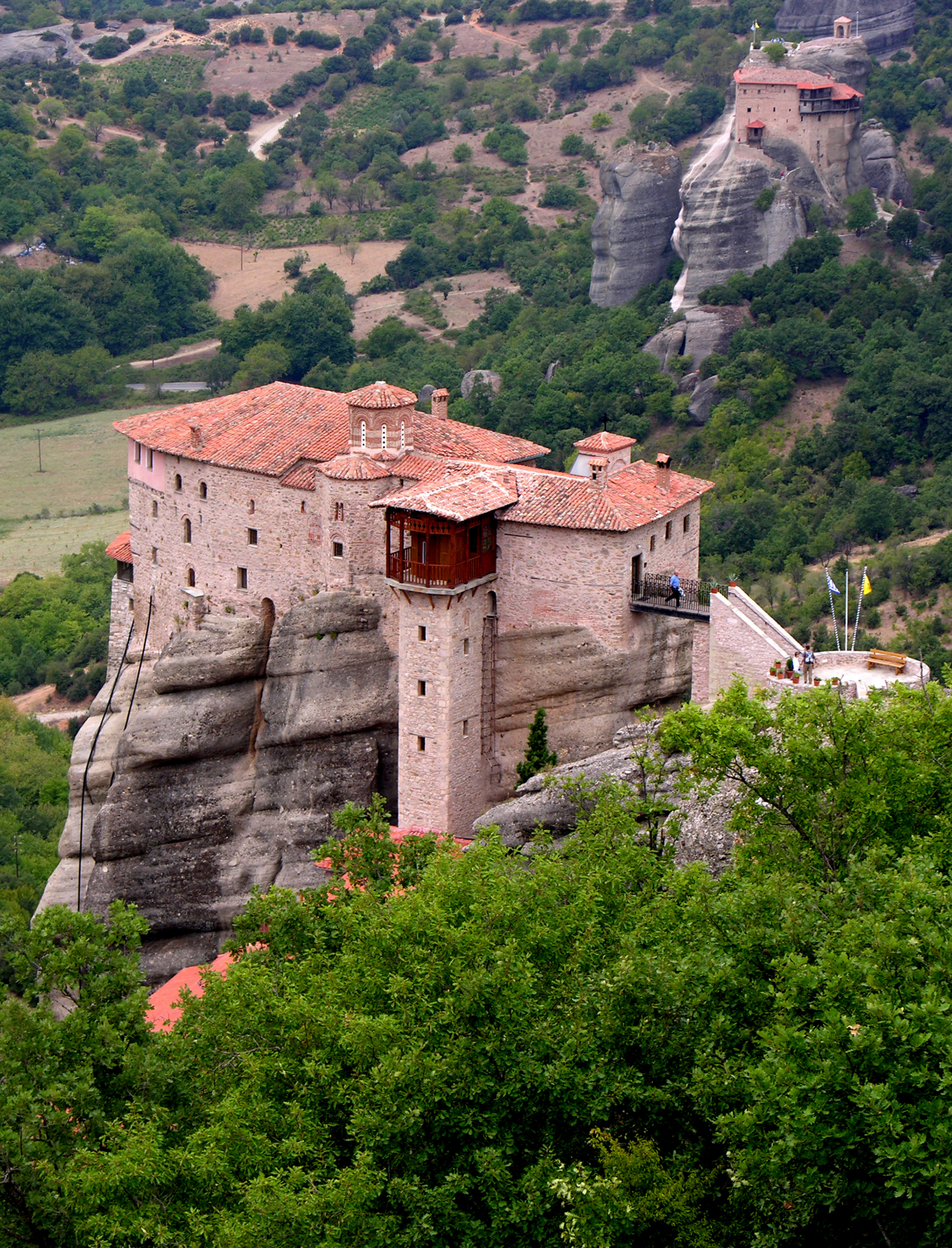 A photograph of a monastery that was built on the top of a very high cliff in Kalambaka, Greece