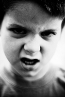 A photograph of a boy who appears to be angry.