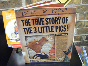A photograph of a book titled “The True Story of the Three Little Pigs” by A. Wolf.