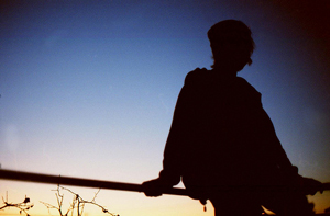 A photograph of a person silhouetted against the sky.