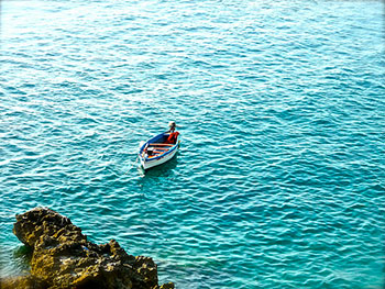 A photograph of a small boat on the water.