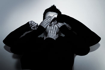 A photograph of a young man acting out all of the five senses in a conceptual photograph.