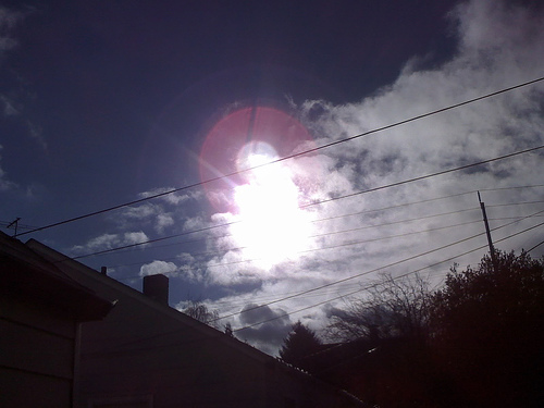 A photograph of a strange bright light in the daytime sky.