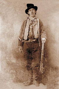 A portrait of the famous outlaw, Billy the Kid. He is a young man wearing a top hat. He is wearing a pistol belt and holding a rifle.