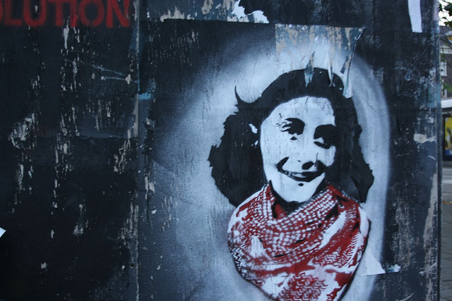 A photograph of a spray painted portrait of Anne Frank