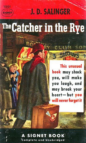 An image of the cover of the book “The Catcher in the Rye” by J.D. Salinger. It has a young man with a suitcase walking down a city street at night.
