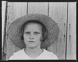 A photograph o f a young girl wearing a sun hat. The photo was taken in the 1930s.