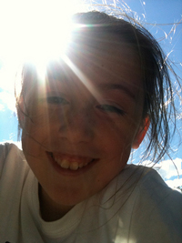 A photograph of sun shining through a young girl's hair