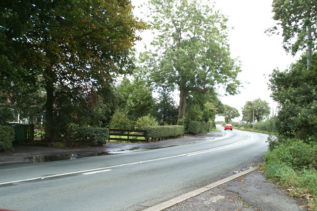 A photograph of a turn in a rural road.