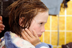 image of unhappy kid with wet hair