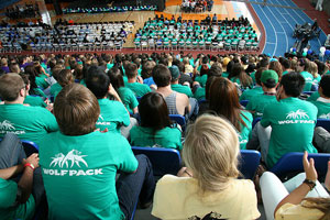 A photograph of an indoor stadium during school orientation. It is full of students