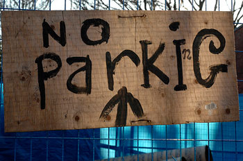 A photograph of a handwritten sign that reads “No Parking with the “n” barely visible due to leaving it out when the sign was first made”
