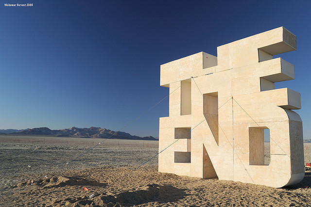 A photograph of a structure of the words “the end” in a desert