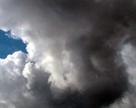 A photograph of dark clouds gathering in the sky