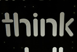 photo of the work “Think” writing in white letters on a black wall