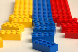 A photograph of a series of Lego blocks line up in rows. The ones closest to the camera are disordered