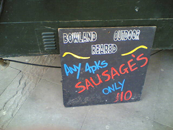 A photograph of a sign advertising, “Any 4 packs sausage’s only 10 pounds.”