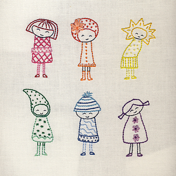 An embroidered cloth with caricatures of happy little girls on it