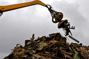 large crane picking up scrap metal