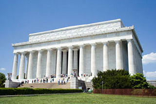 A photograph of the Lincoln Memorial in Washington D.C. It is a large structure in classical Greek style with numerous columns supporting a roof decorated with carved designs.